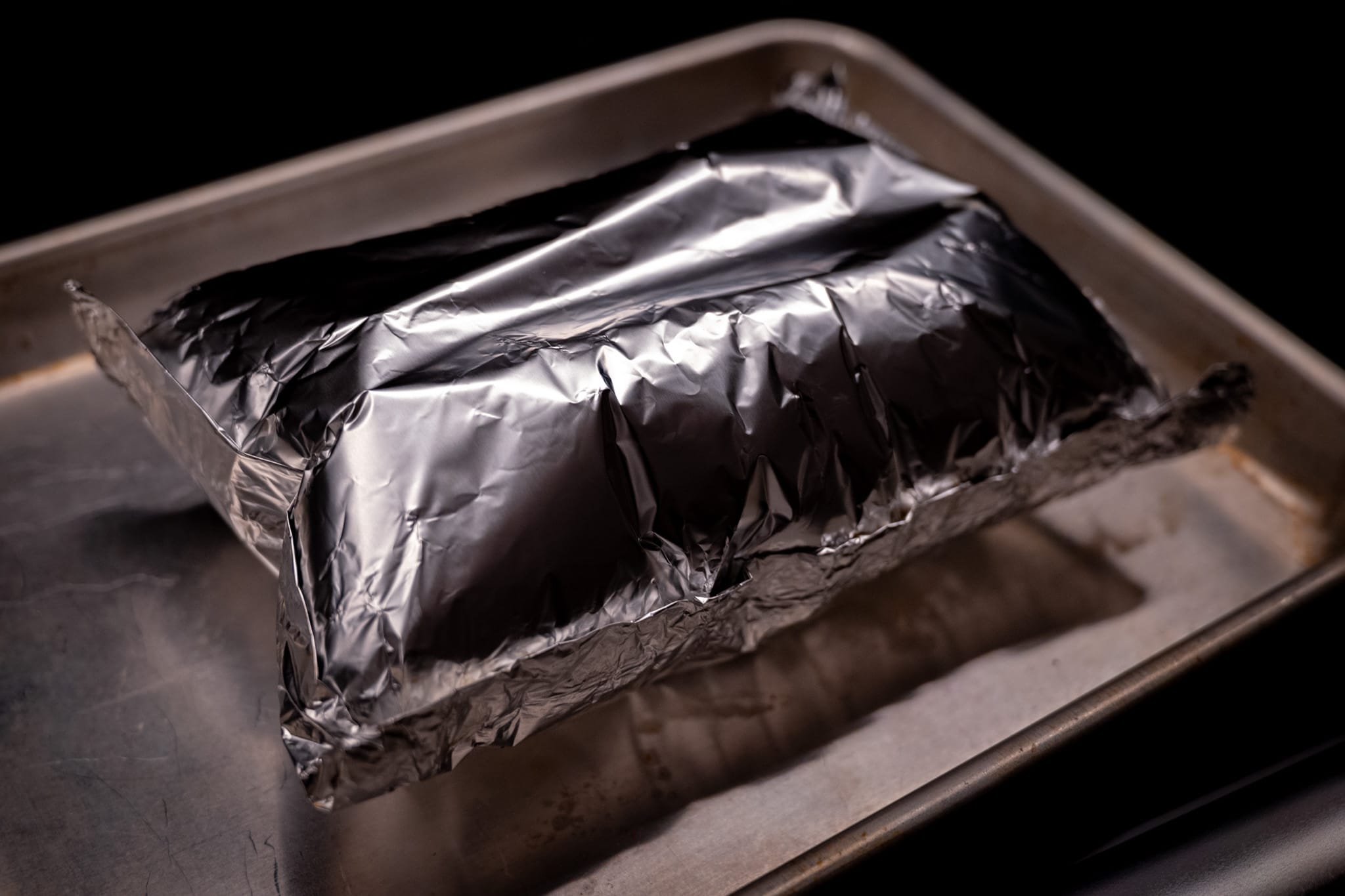 Fish in a foil pouch on a quarter sheet tray