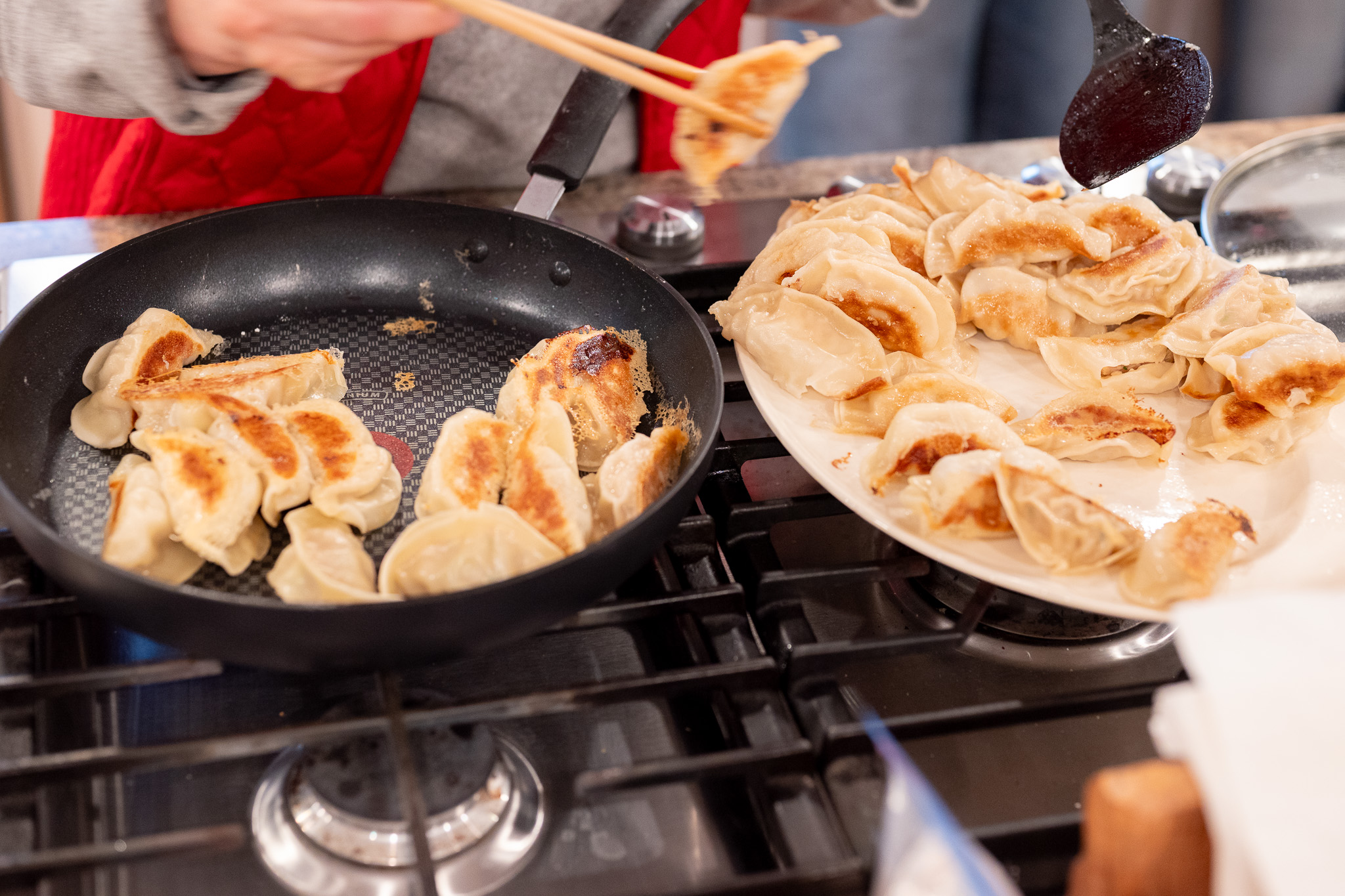 Gyoza being transferred to a dish