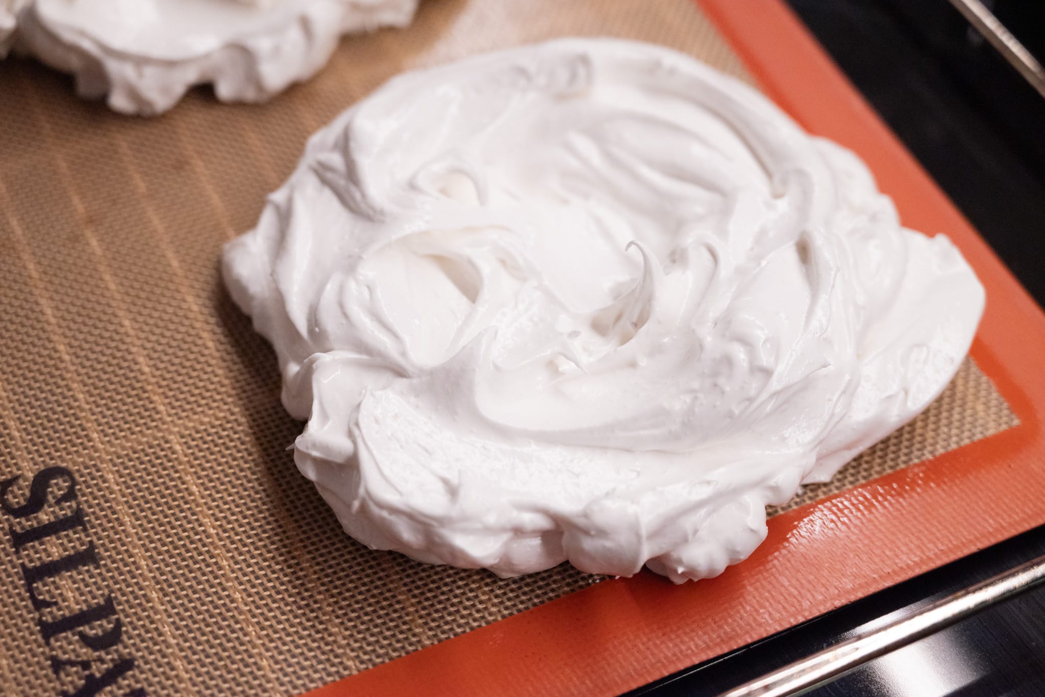 Meringues portioned on a Silpat