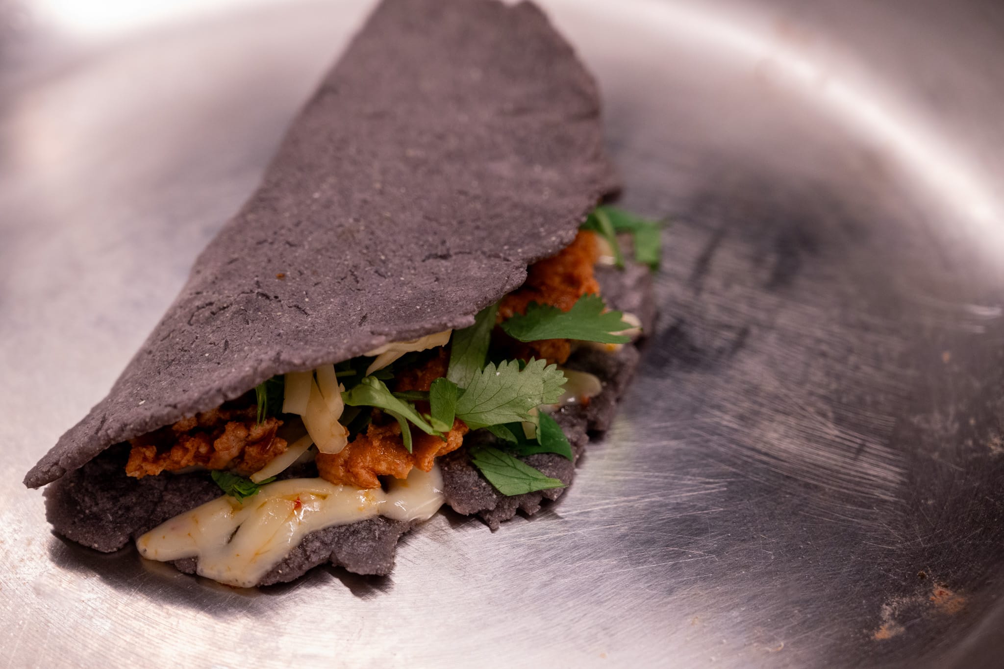 Three quesadillas on a white plate